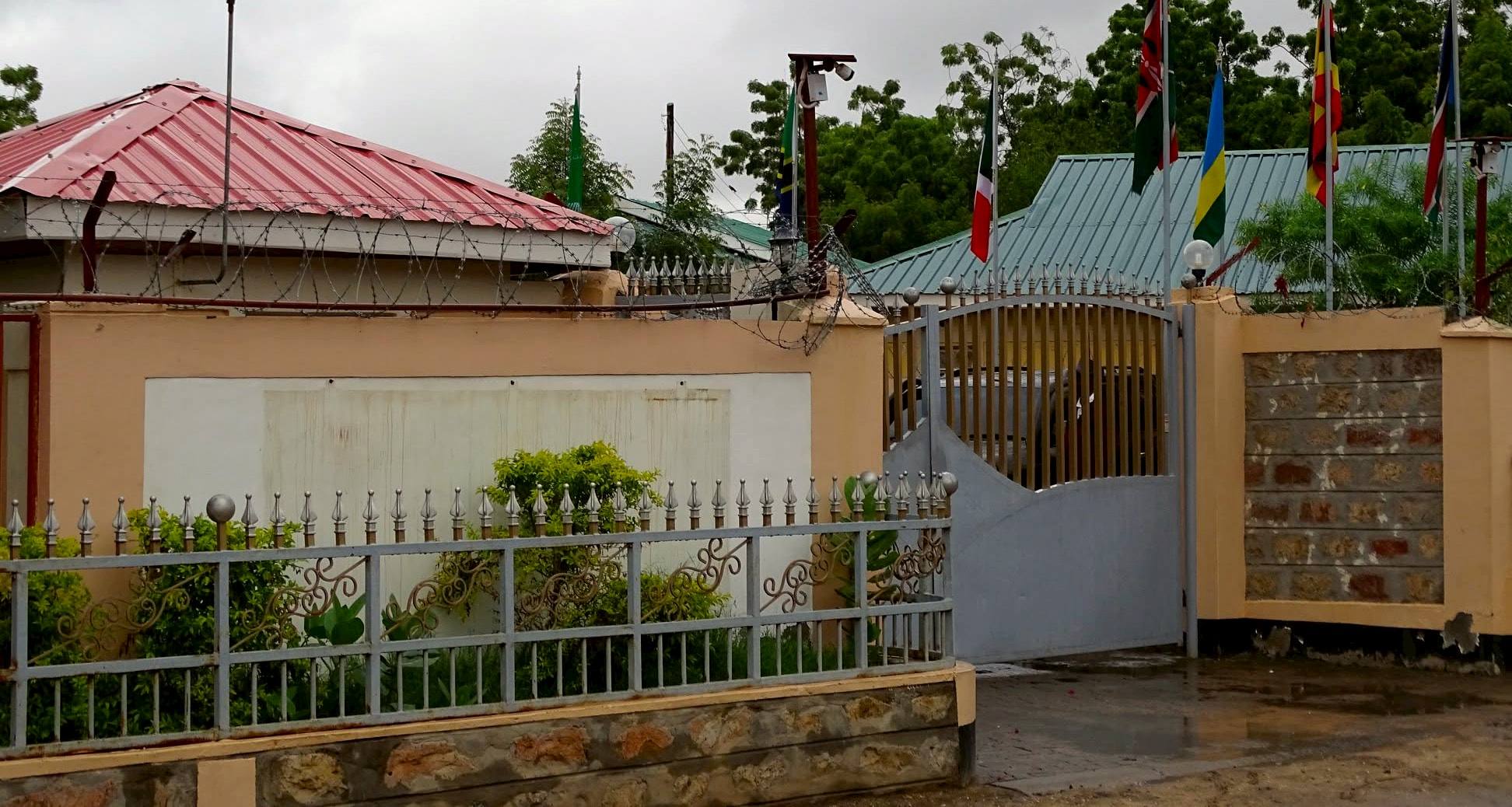 Flags of East African nations flying above the lodge gate and garden wall