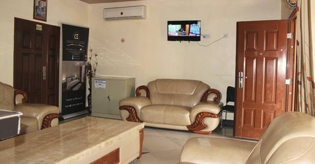 A lounge with cream leather armchairs and a low table