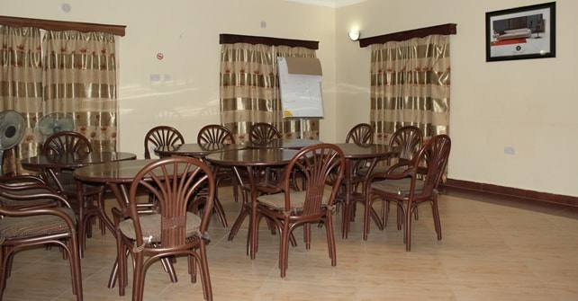 A smaller meeting room with round tables and a flip chart