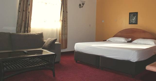 VIP Ensuite room with sofa, coffee table and king bed